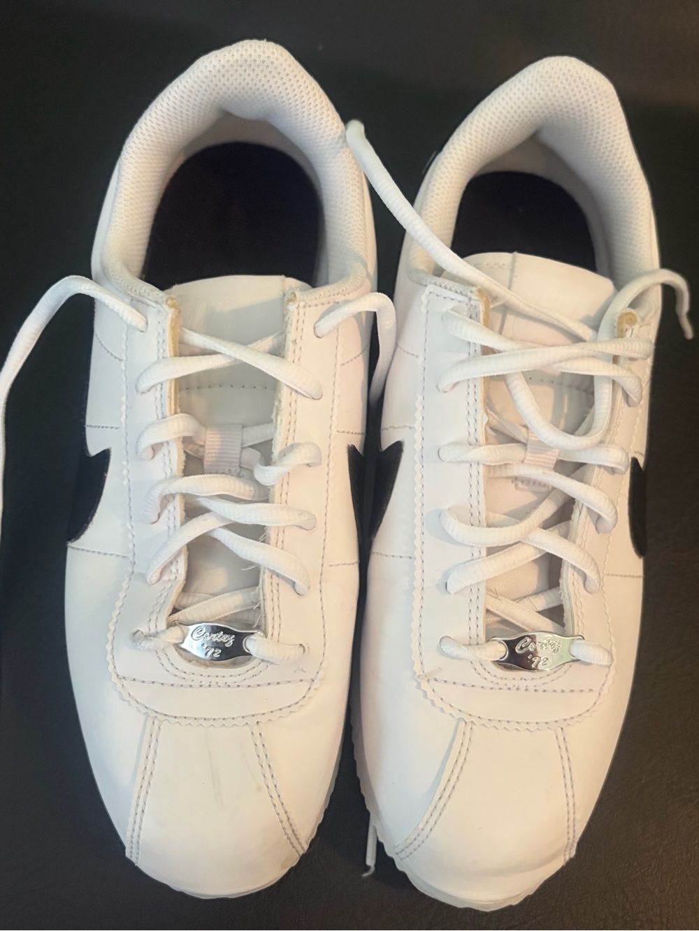 Nike Kids White Sneakers with Black Swoosh Accent